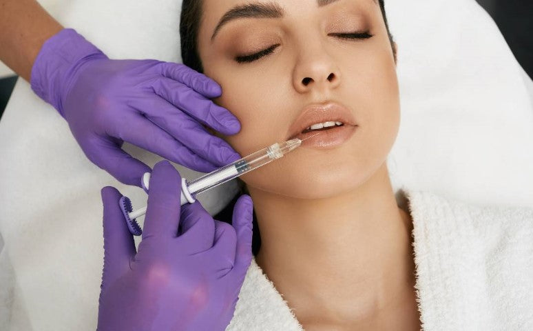 Injector doing lip fillers on a woman and an article about lip filler aftercare is underneath.